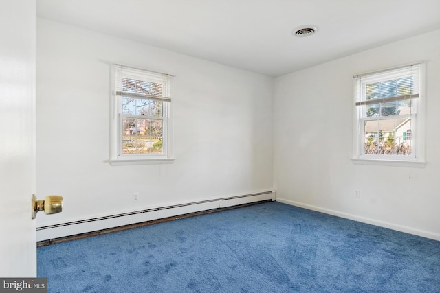 carpeted spare room featuring baseboard heating