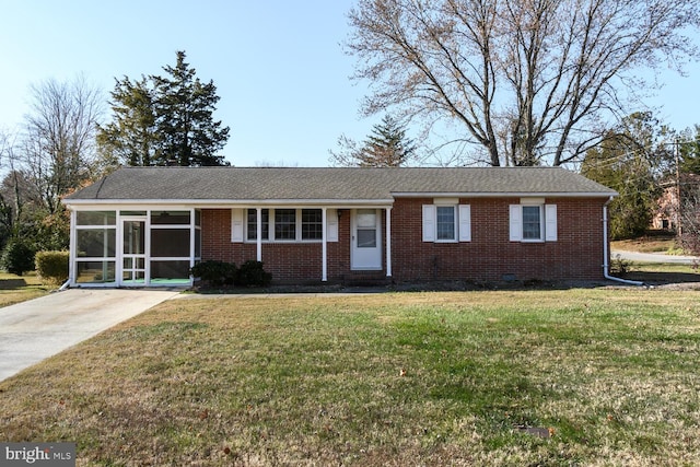 ranch-style home with a sunroom and a front lawn