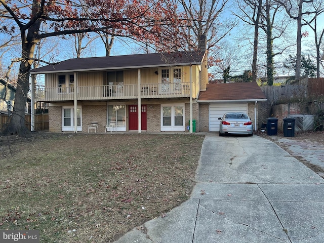 view of front property with a balcony, a garage, and a front lawn