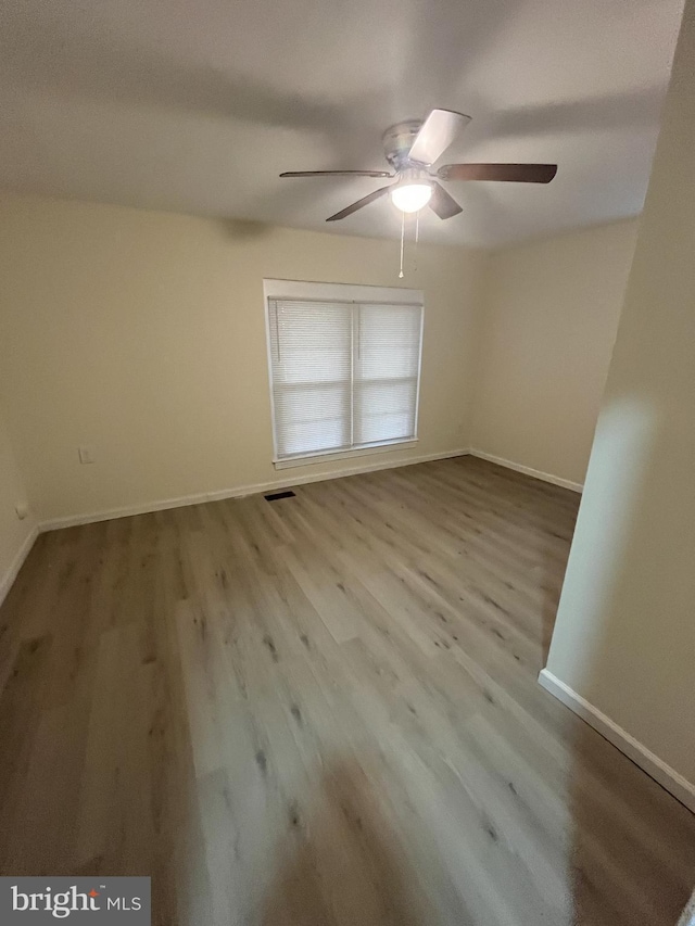 spare room featuring ceiling fan and light hardwood / wood-style floors