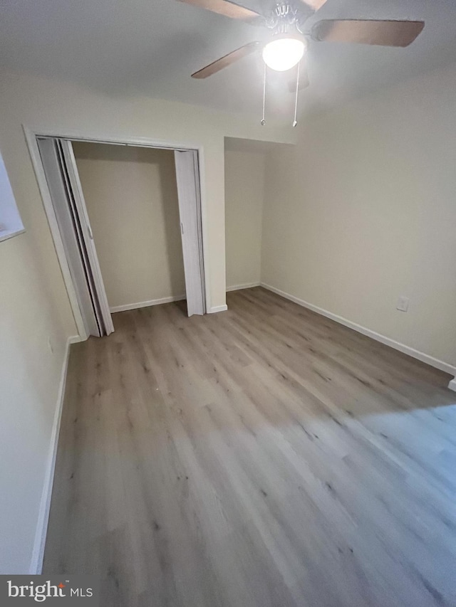 unfurnished bedroom with light wood-type flooring and ceiling fan