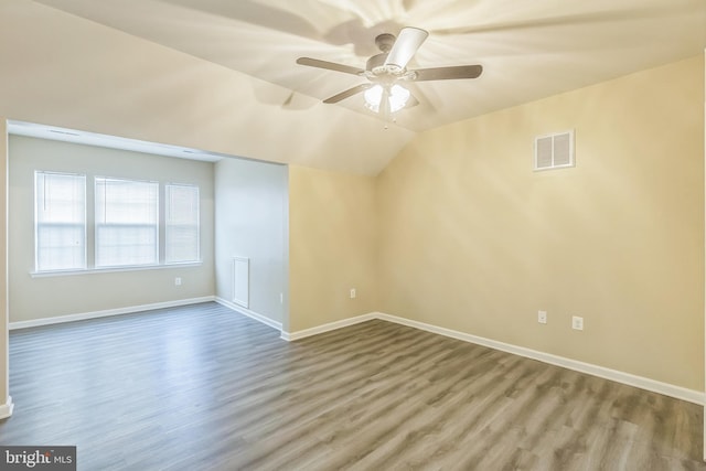 unfurnished room with ceiling fan, hardwood / wood-style floors, and lofted ceiling