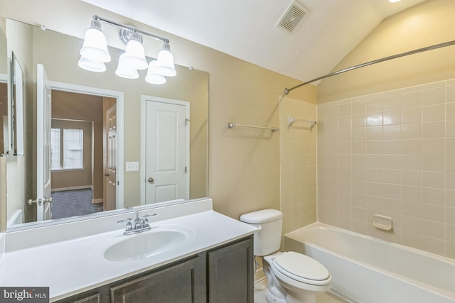 full bathroom featuring toilet, vanity, tiled shower / bath combo, and lofted ceiling