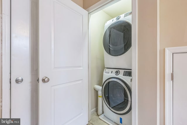 laundry area featuring stacked washer and clothes dryer