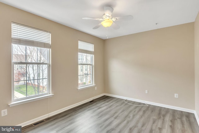 empty room with light wood-type flooring and ceiling fan