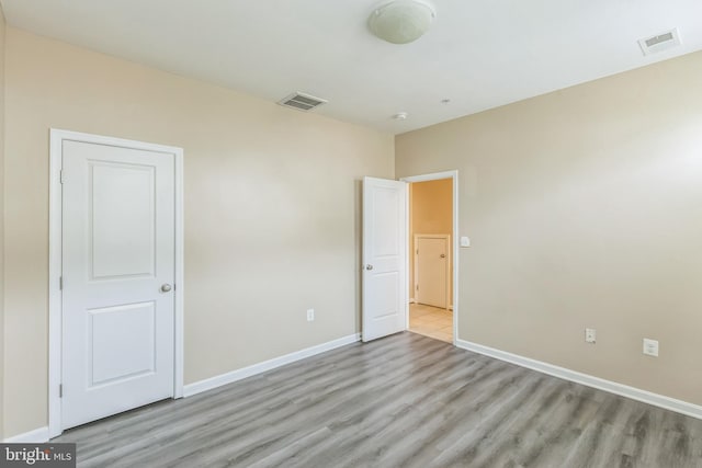 unfurnished bedroom featuring light wood-type flooring