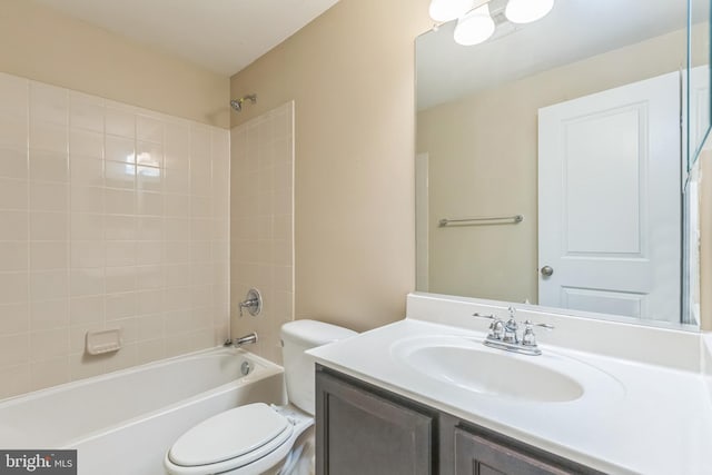 full bathroom with toilet, vanity, and tiled shower / bath