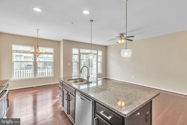 kitchen with an island with sink, stainless steel dishwasher, a wealth of natural light, and sink