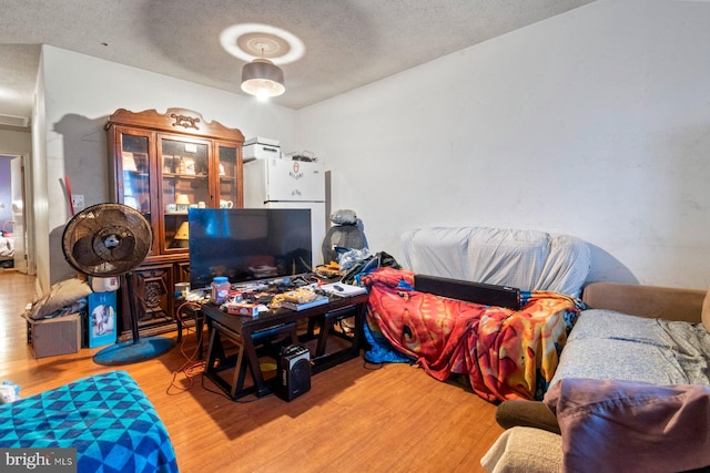 interior space featuring a textured ceiling and light hardwood / wood-style flooring