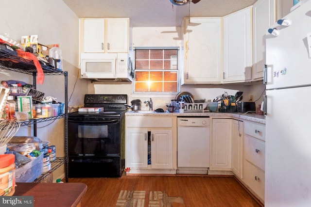 kitchen featuring white cabinets, white appliances, and light hardwood / wood-style floors