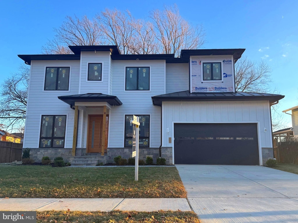 view of front of home featuring a garage and a front lawn