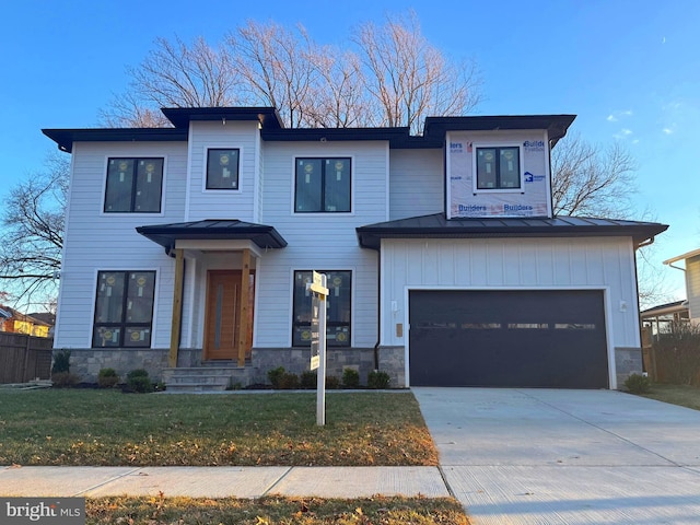 view of front of home featuring a garage and a front lawn