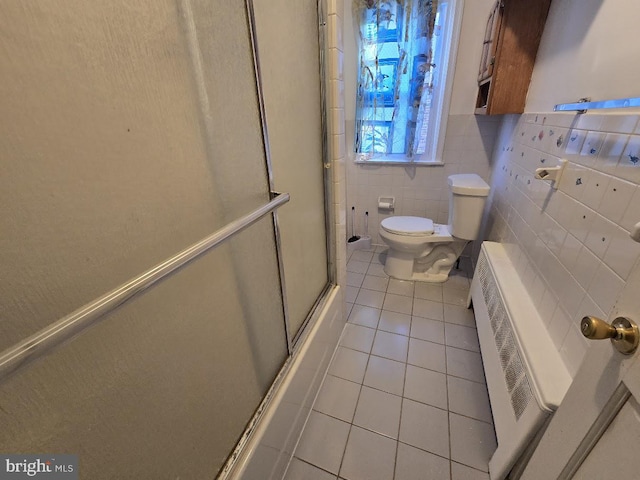 bathroom with walk in shower, tile patterned floors, mail boxes, toilet, and tile walls