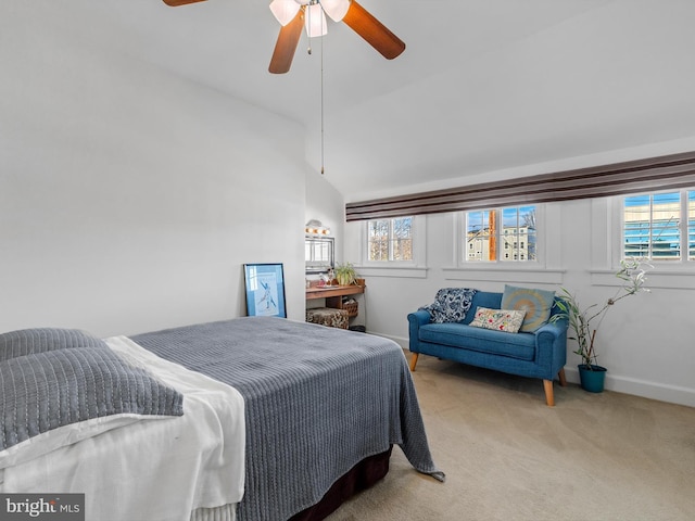 carpeted bedroom with multiple windows, ceiling fan, and lofted ceiling