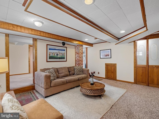 living room with a textured ceiling, carpet floors, crown molding, and wooden walls