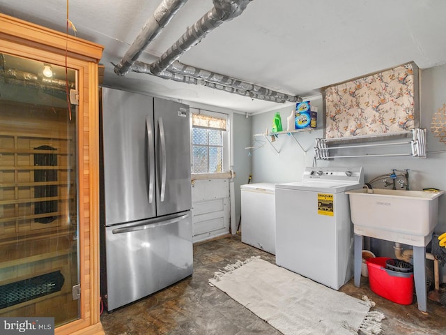 laundry room featuring washer and clothes dryer and sink