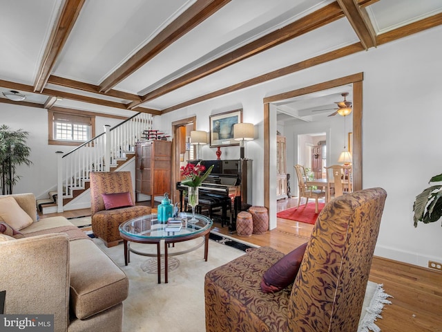 living room with beam ceiling, light hardwood / wood-style flooring, and ceiling fan