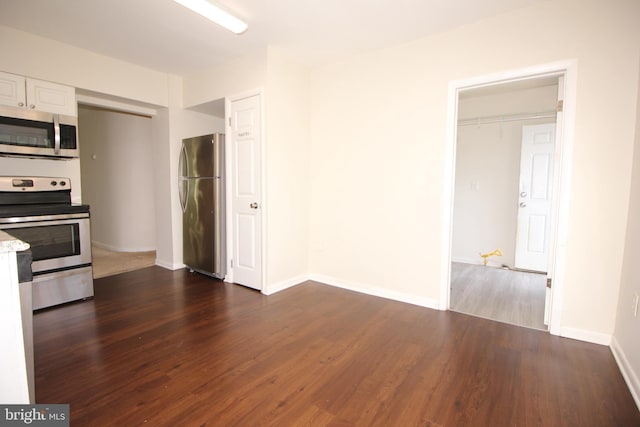 kitchen with white cabinetry, dark wood-type flooring, and appliances with stainless steel finishes