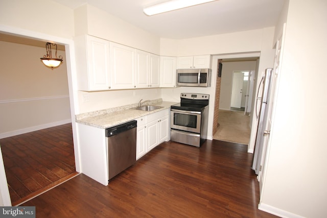 kitchen with sink, white cabinets, dark hardwood / wood-style floors, and appliances with stainless steel finishes