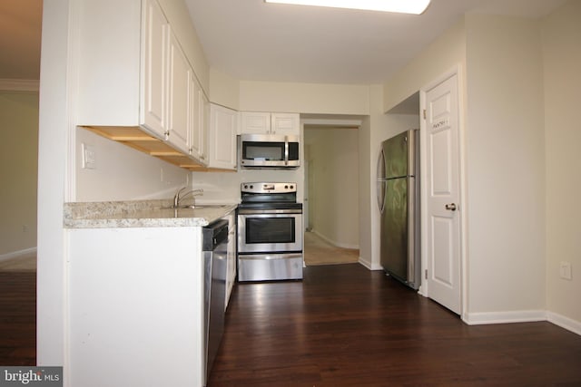 kitchen featuring sink, white cabinets, stainless steel appliances, and dark hardwood / wood-style floors