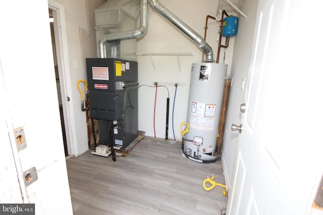 utility room with heating unit and water heater