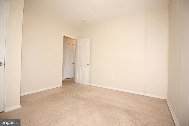 unfurnished room with light carpet