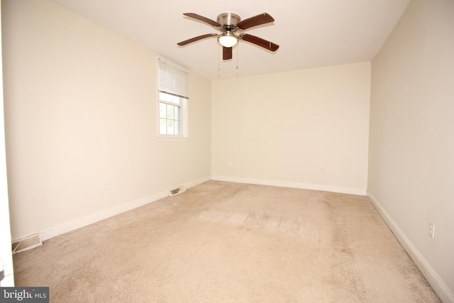 carpeted spare room with ceiling fan