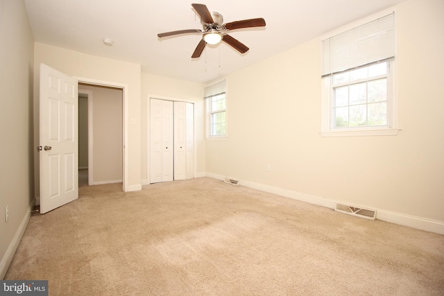 unfurnished bedroom featuring ceiling fan and light carpet