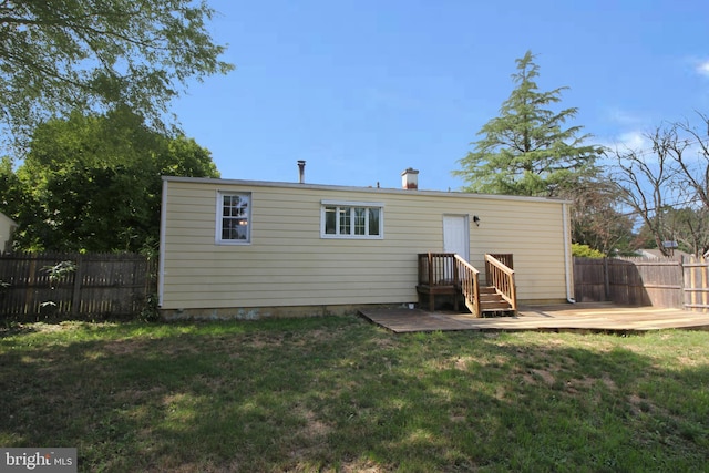 back of house with a yard and a deck