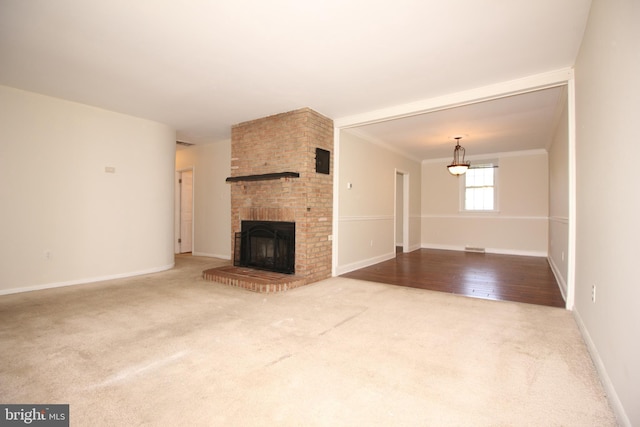 unfurnished living room with a fireplace, hardwood / wood-style flooring, and ornamental molding