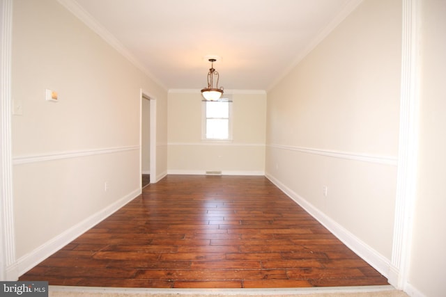 spare room featuring dark hardwood / wood-style flooring and ornamental molding