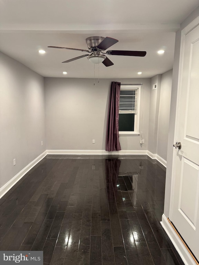 spare room featuring ceiling fan and dark hardwood / wood-style flooring