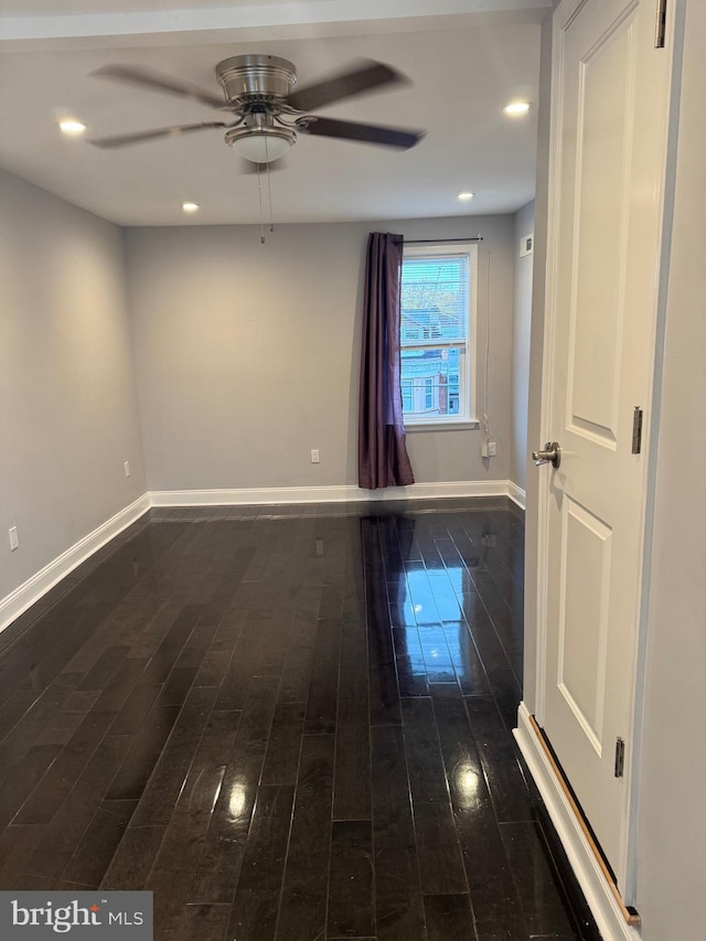 unfurnished room featuring dark hardwood / wood-style flooring and ceiling fan