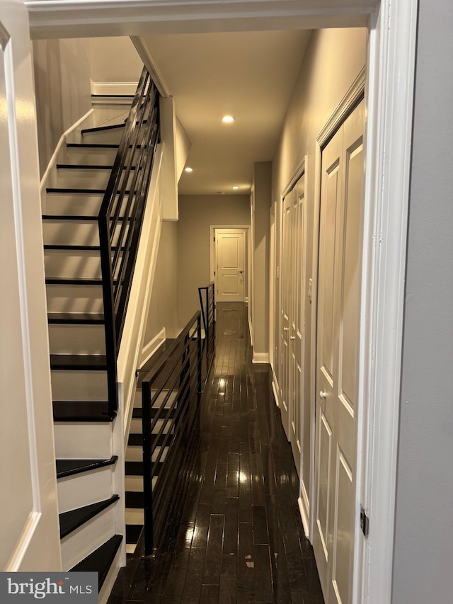 hallway with dark hardwood / wood-style floors