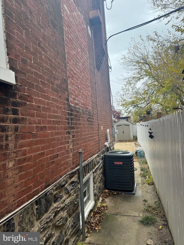 view of home's exterior with a shed and central air condition unit