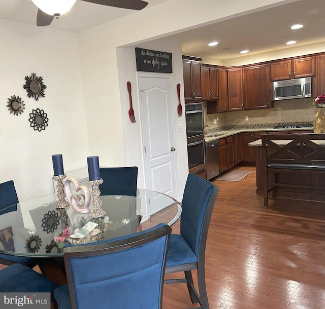 dining area with wood-type flooring and recessed lighting