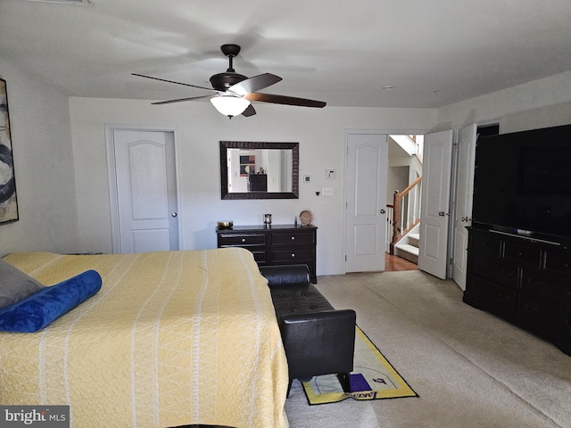 bedroom featuring ceiling fan and carpet