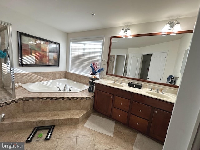 full bath featuring double vanity, a garden tub, tile patterned flooring, and a sink