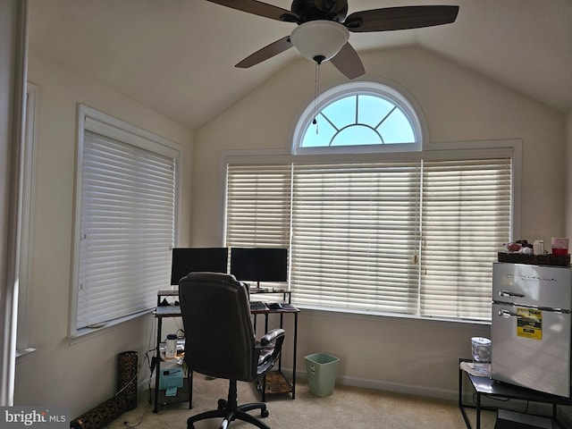 carpeted office space featuring lofted ceiling, ceiling fan, and baseboards