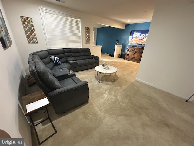 carpeted living area featuring visible vents and baseboards