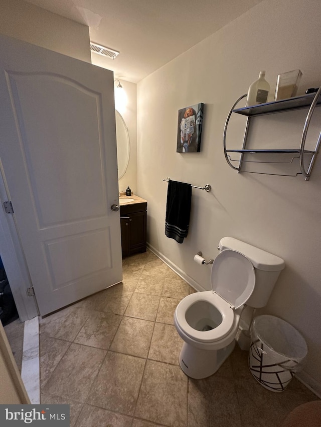 bathroom featuring tile patterned flooring, visible vents, vanity, and toilet