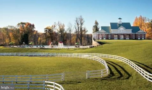 view of property's community featuring a yard and a rural view