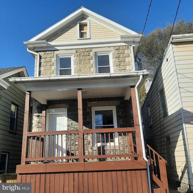 rear view of house featuring a porch