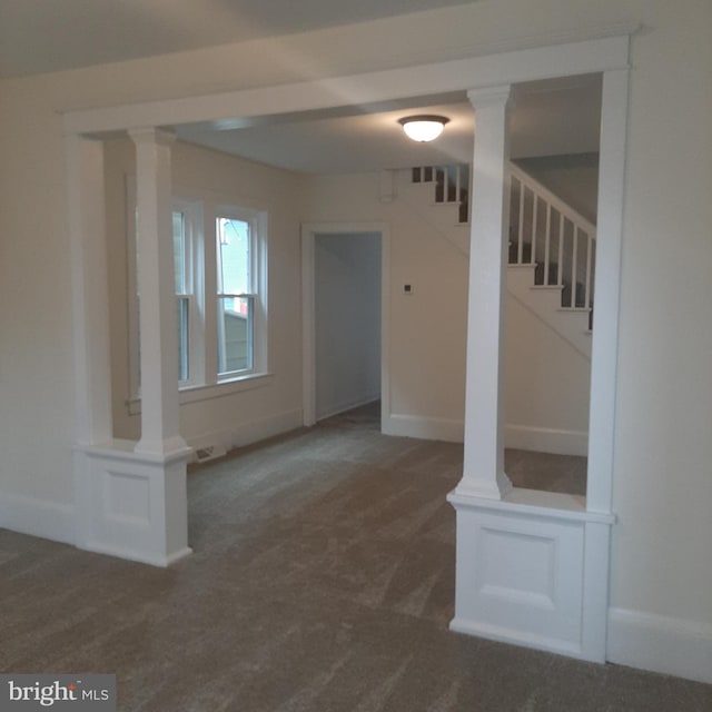 unfurnished room featuring dark colored carpet