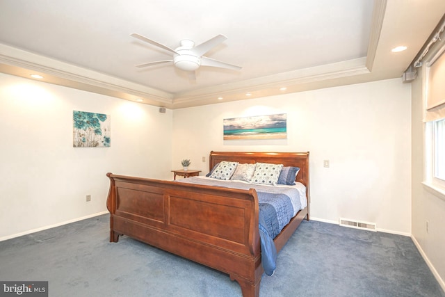 carpeted bedroom with a tray ceiling, ceiling fan, and crown molding