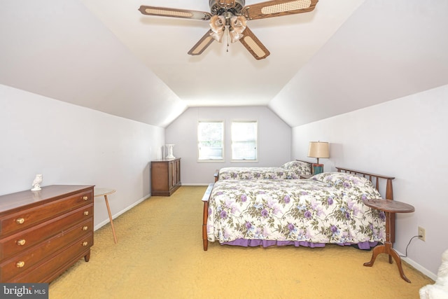 bedroom with ceiling fan, light colored carpet, and vaulted ceiling