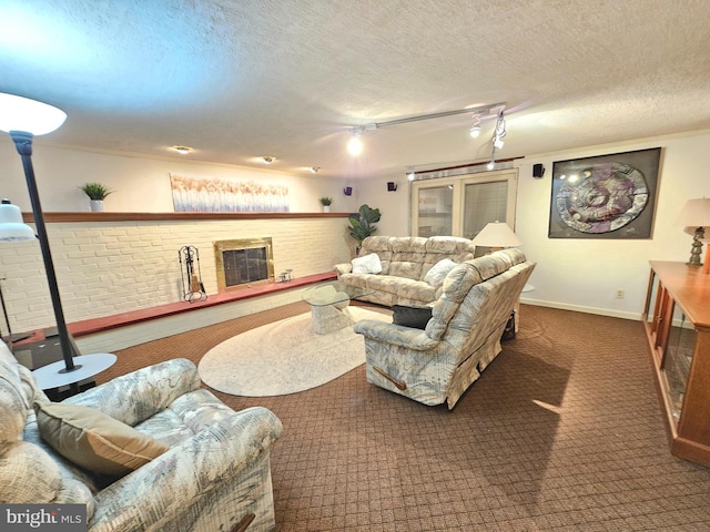 carpeted living room featuring a textured ceiling and rail lighting