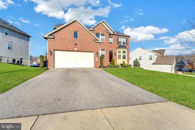 view of front of home featuring a front yard and a garage