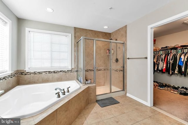 bathroom featuring tile patterned flooring and separate shower and tub