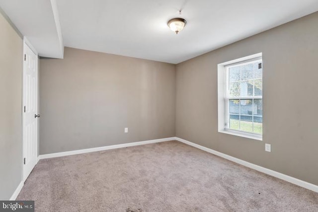 unfurnished room featuring light colored carpet